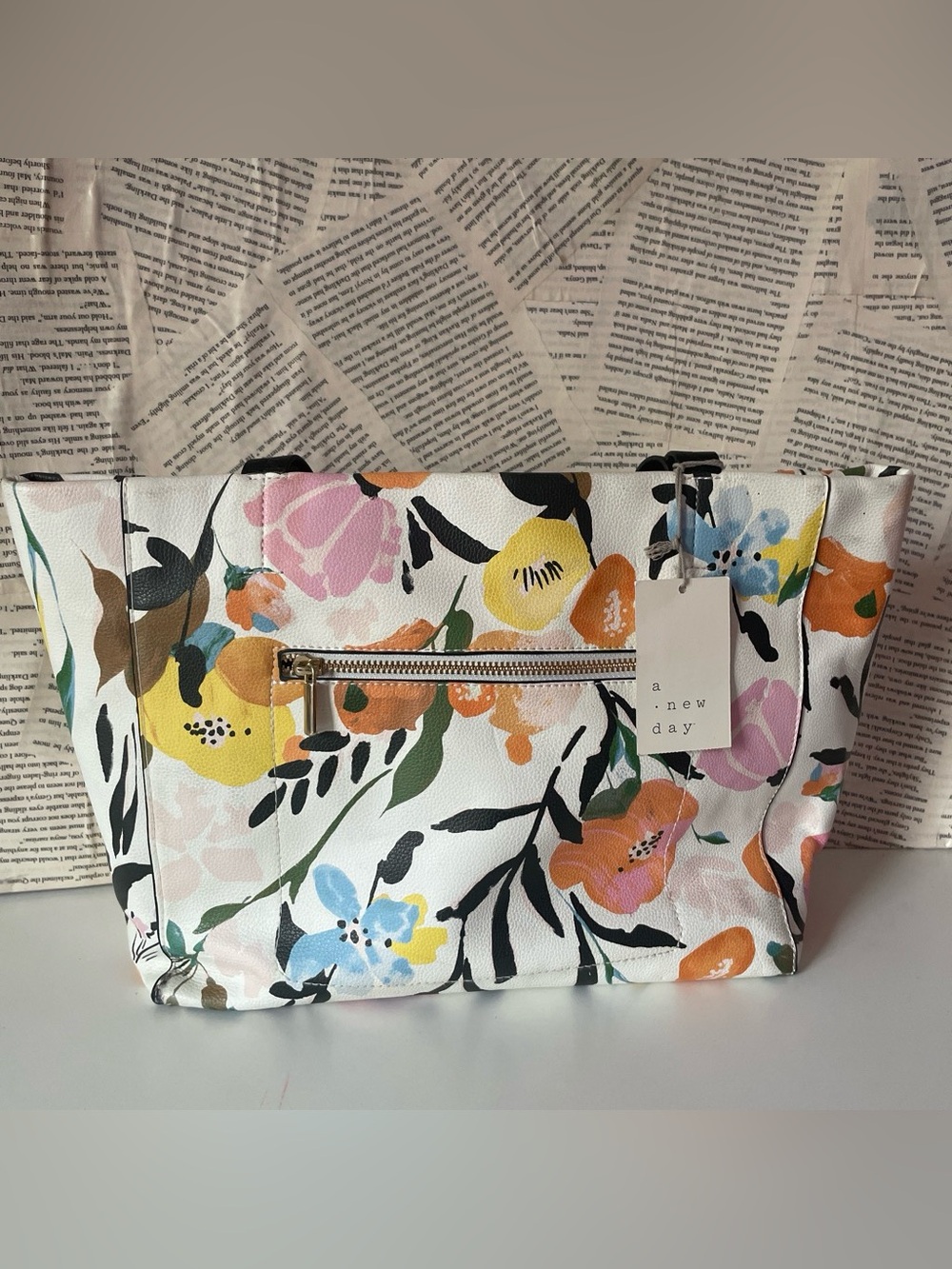 A New Day white floral clutch with pink, yellow, and blue flowers, green leaves